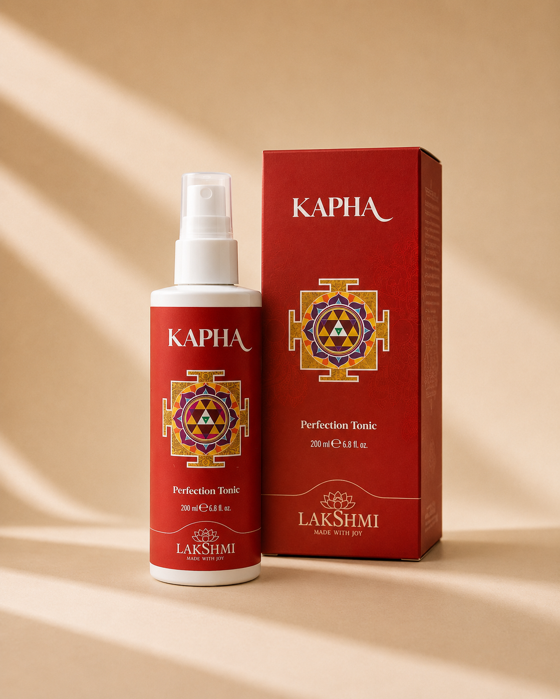 Lakshmi KAPHA Perfection Tonic bottle and red box in soft shadow