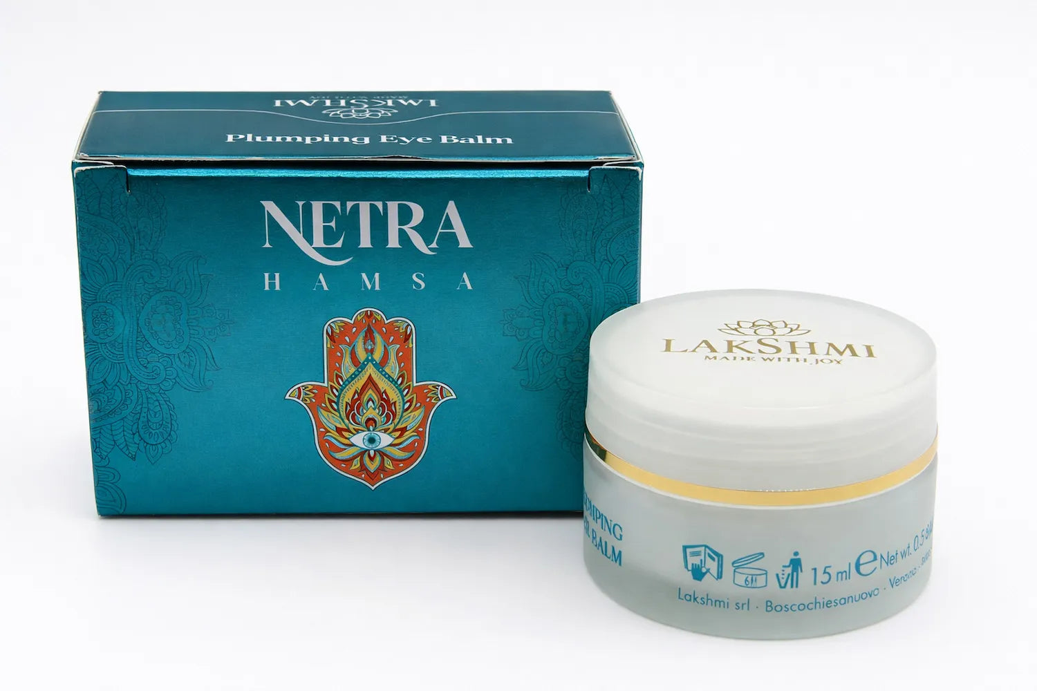 Lakshmi NETRA Plumping Eye Balm box beside its frosted glass jar