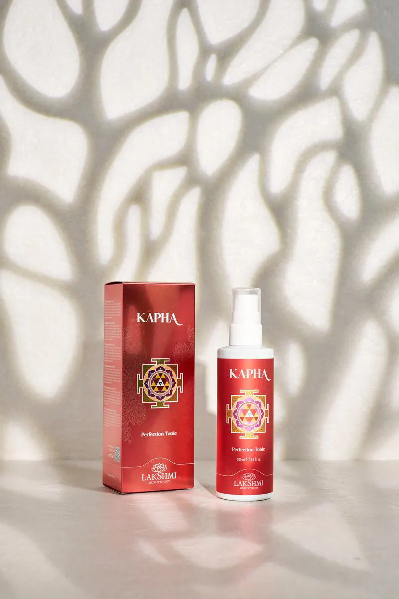 Lakshmi KAPHA Perfection Tonic bottle standing beside its red box