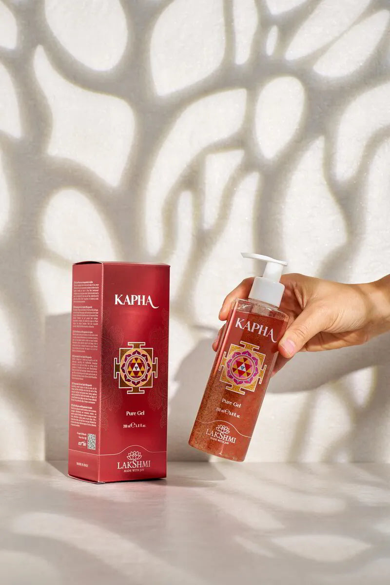 Hand lifting the Lakshmi KAPHA Pure Gel bottle from beside its box