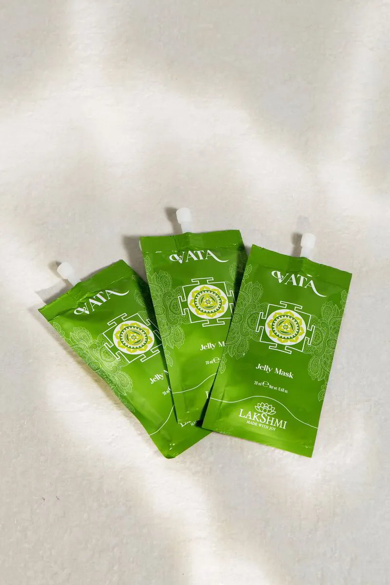 Three Lakshmi VATA Jelly Mask sachets fanned out in dappled light