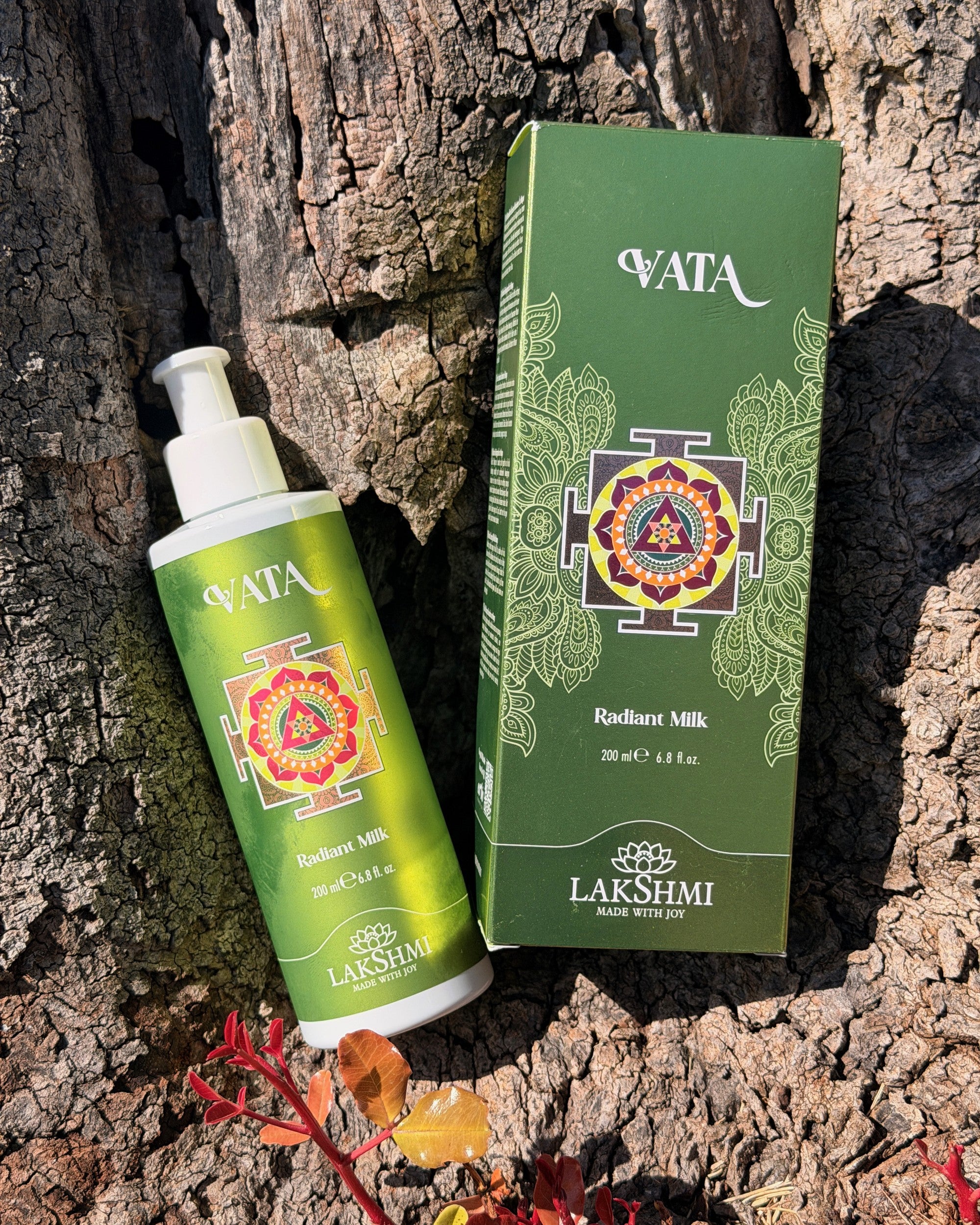 Lakshmi VATA Radiant Milk bottle and box against olive bark